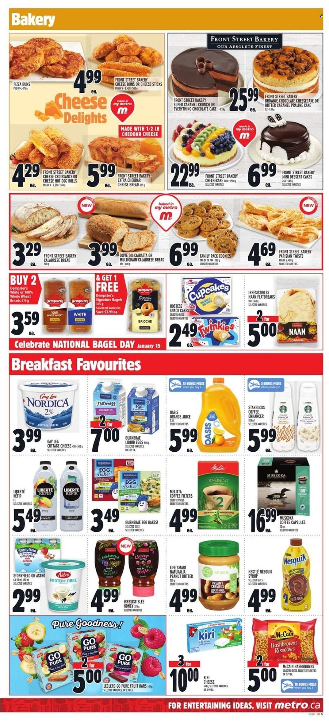 thumbnail - Metro Flyer - January 13, 2022 - January 19, 2022 - Sales products - bagels, bread, hot dog rolls, cake, buns, brioche, cupcake, cheesecake, brownies, chocolate cake, pizza, cottage cheese, cheddar, Kiri, Clover, kefir, eggs, cheese sticks, McCain, hash browns, cookies, chocolate, snack, caramel, olive oil, oil, honey, peanut butter, syrup, orange juice, juice, coffee, coffee capsules, Starbucks, Absolute, Nesquik, Nestlé, ciabatta. Page 6.