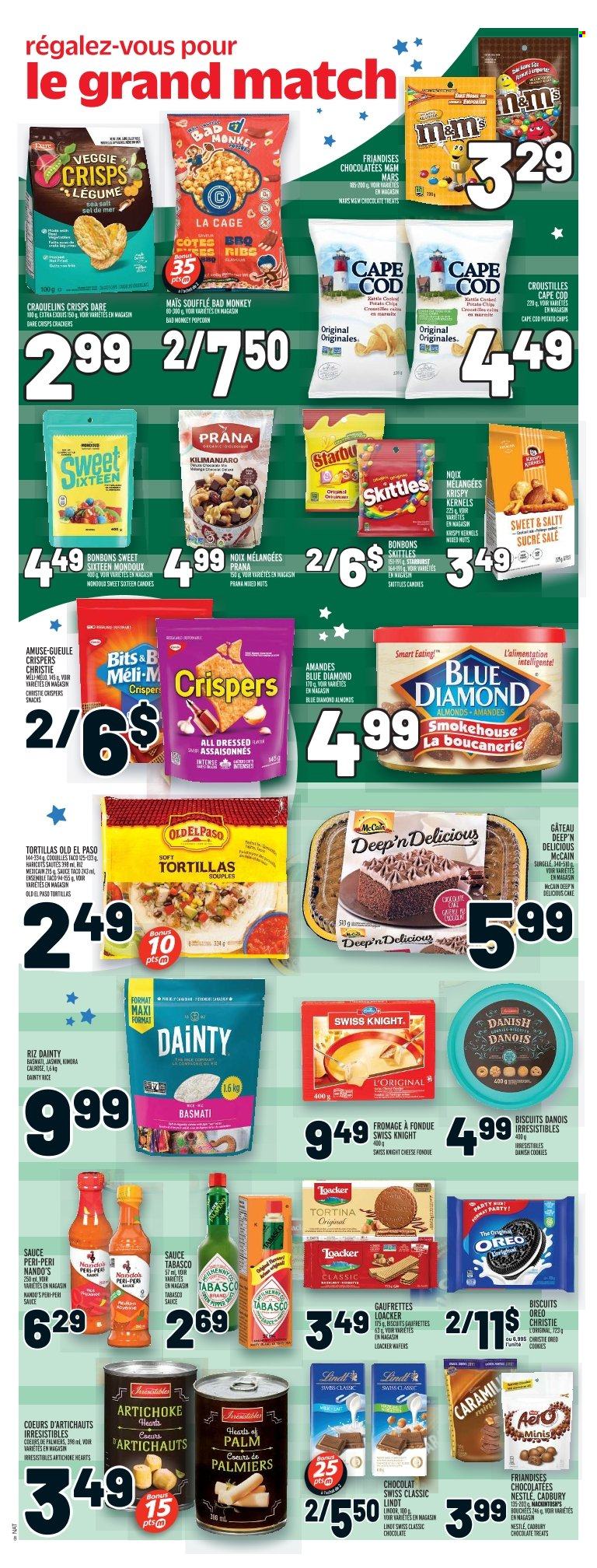 thumbnail - Metro Flyer - February 09, 2023 - February 15, 2023 - Sales products - tortillas, cake, Old El Paso, artichoke, hearts of palm, cod, sauce, milk, McCain, cookies, wafers, chocolate, snack, Mars, crackers, biscuit, Cadbury, Skittles, Starburst, potato chips, chips, popcorn, tabasco, basmati rice, rice, almonds, mixed nuts, Blue Diamond, ribs, cage, Nestlé, Oreo, Lindt, Lindor, M&M's. Page 10.